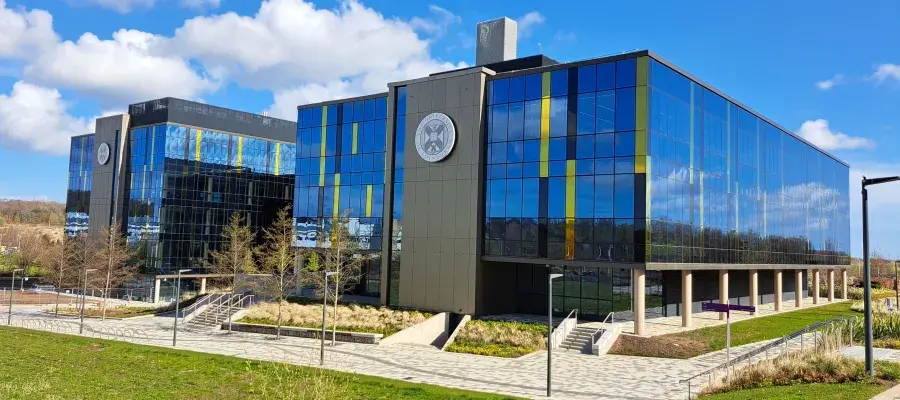 IRR South building in the sunshine - external view with blue skies and clouds