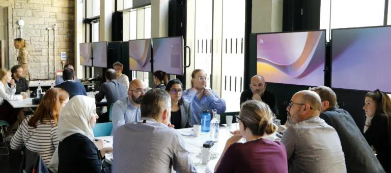 Group of participants in discussion around a table