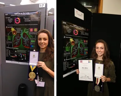 PhD student Helen Parker stands next to her poster, holding her gold medal and certificate