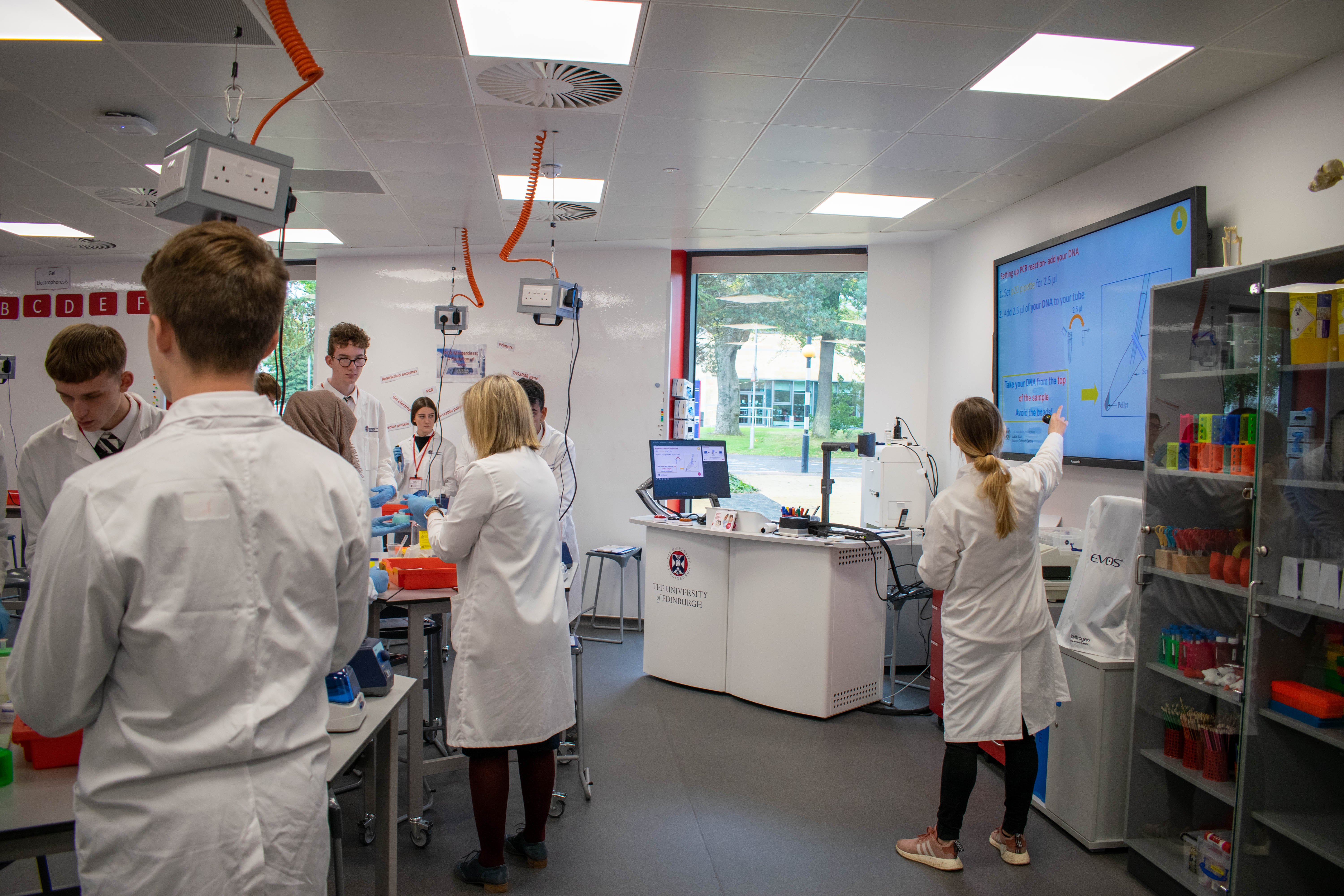 Elena Dora shows pupils how to complete a PCR protocol