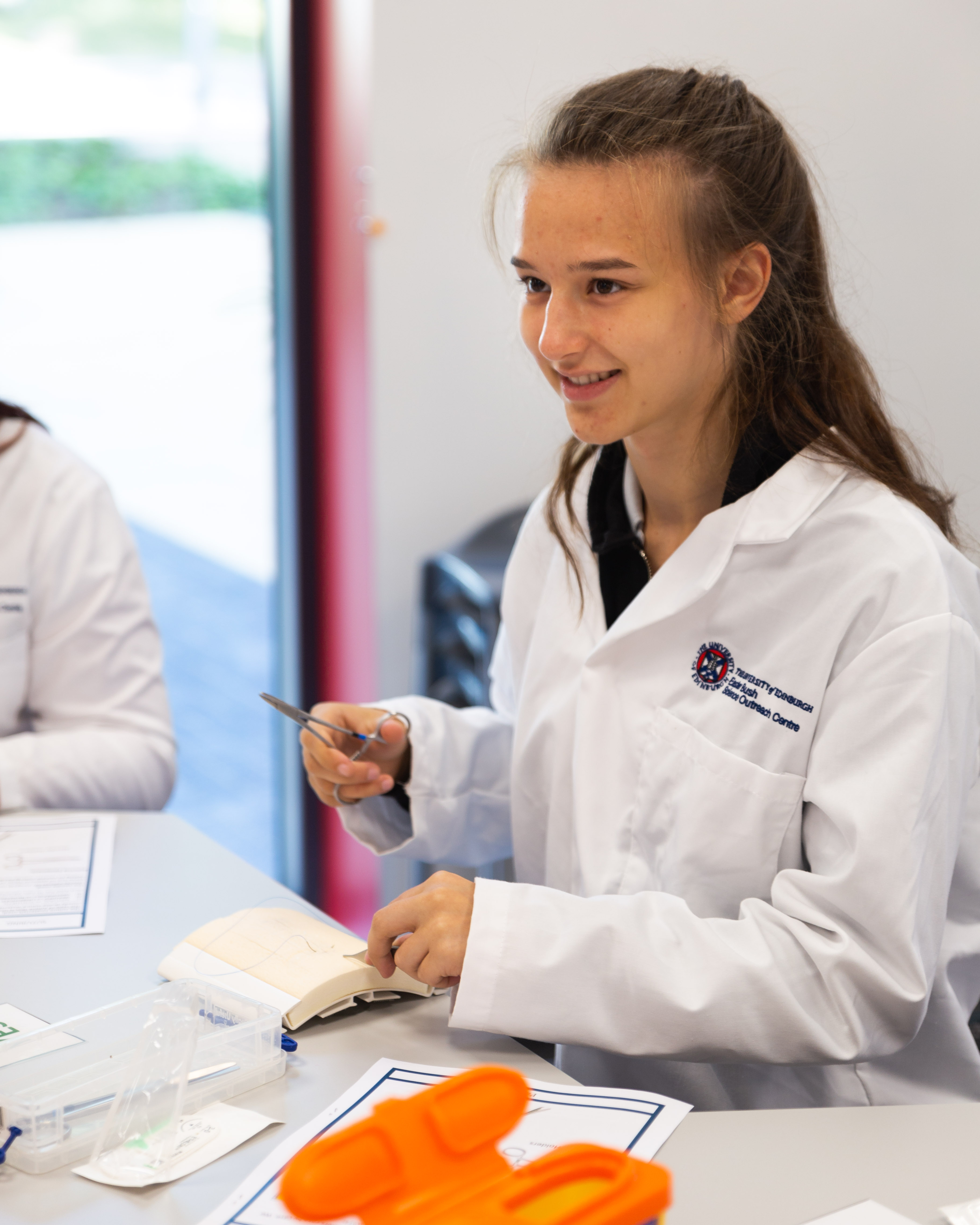 Pupil Rachel Kelsey in a lab coat 