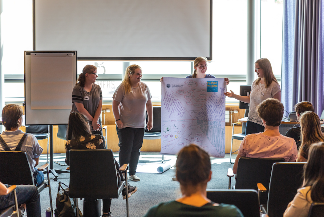 4 pupils present a poster to the rest of the class 